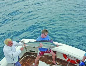 The Barmy Army about to release a black marlin caught while they were on tour.